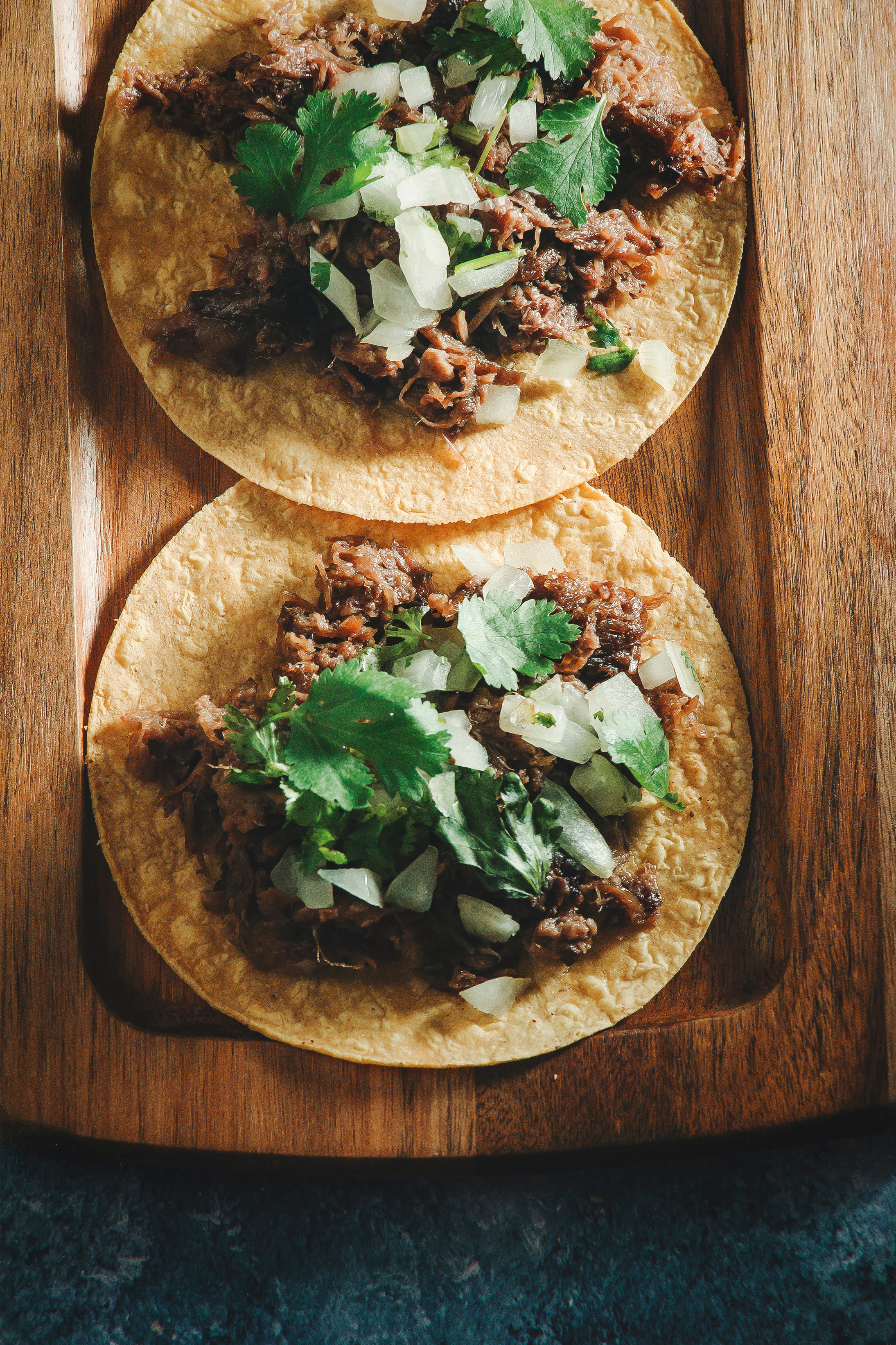 Tacos with Beef Barbecue, Coriander and Onions on Wooden Tray